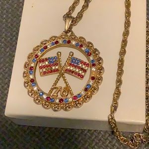 Bicentenial pendant. Red,white and blue flag. Goldtone chain.